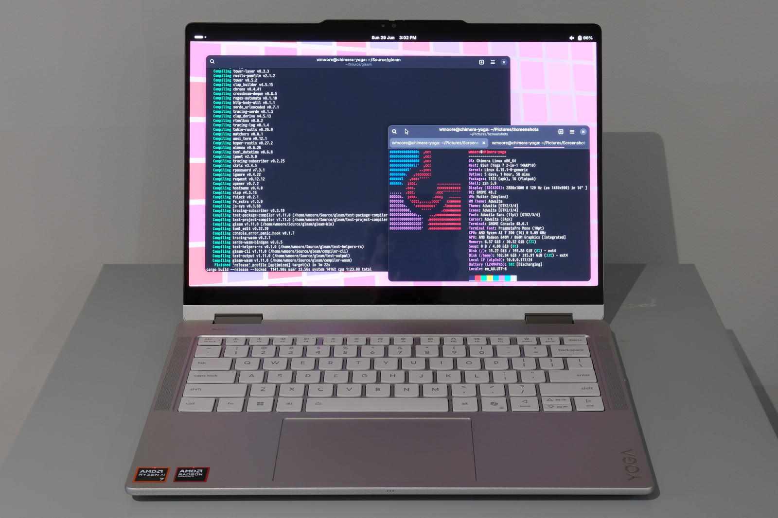 Lenovo Yoga 7 2-in-1 sitting open with two windows in GNOME open