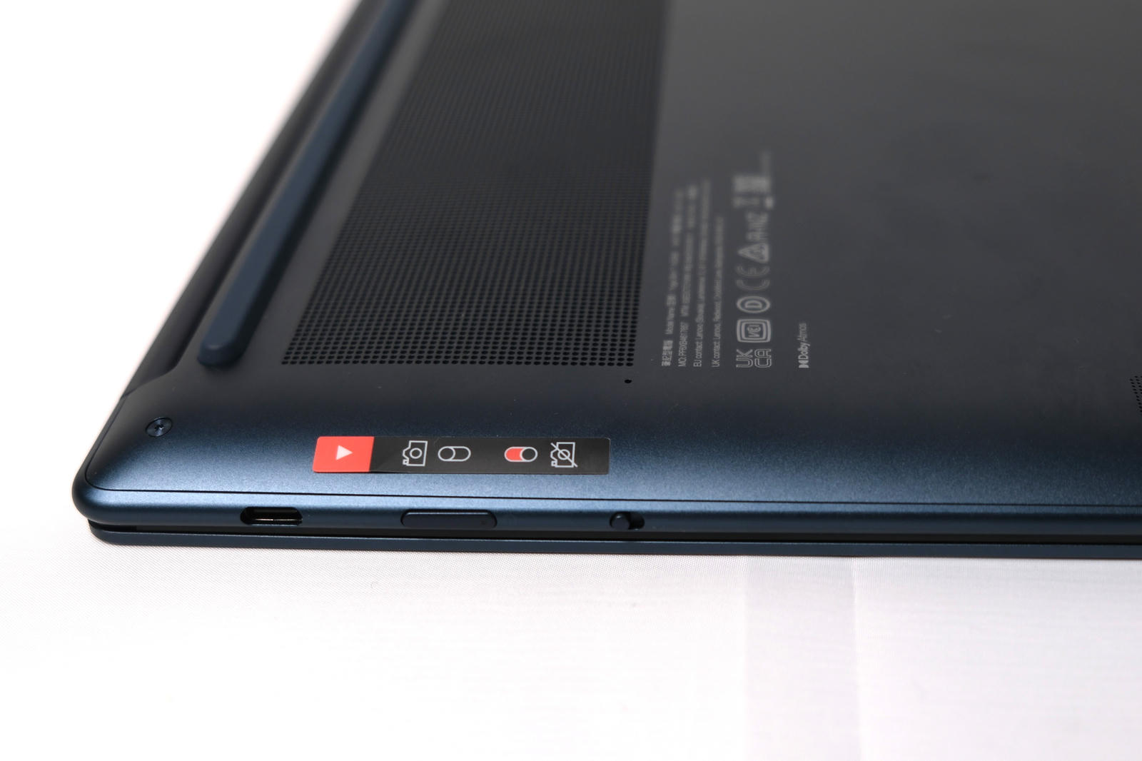 Photo of the laptop upside-down showing the camera privacy switch.