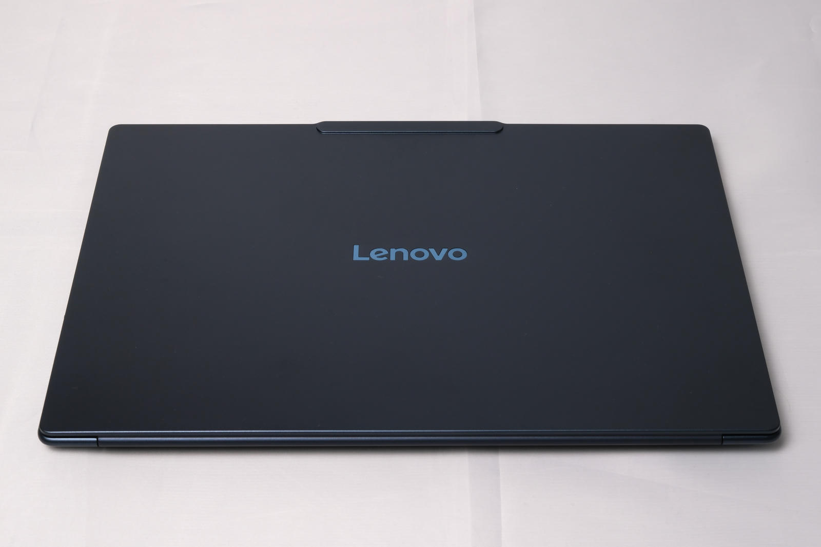 Photo of the top of the laptop showing the Lenovo detail in the middle.