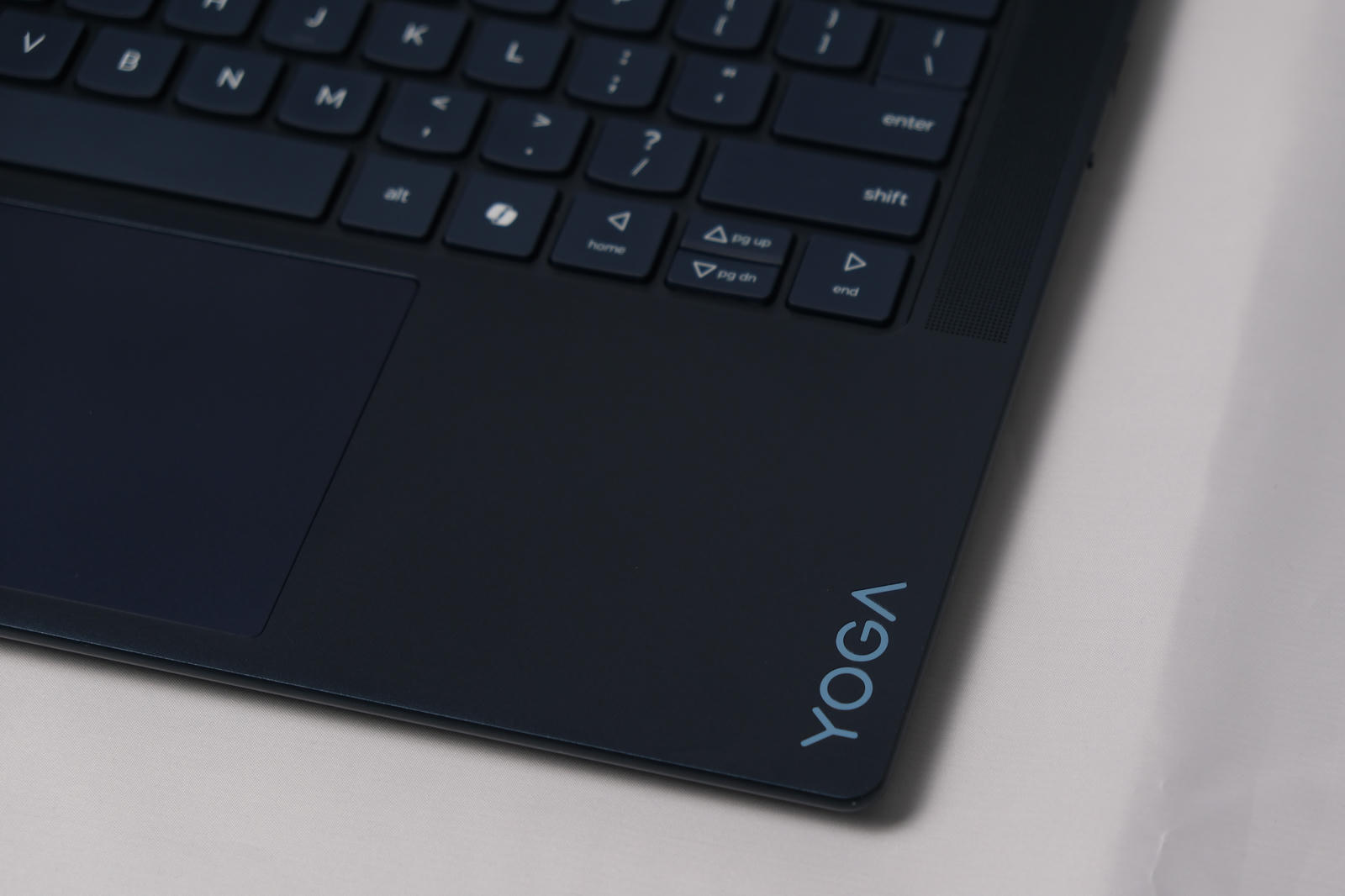 Photo of the laptop at and angle showing the YOGA detail on the right-side palm rest.